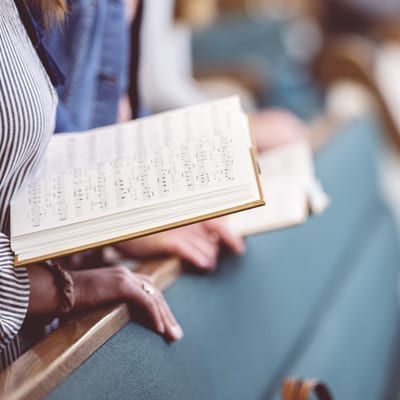 women singing hymns in church